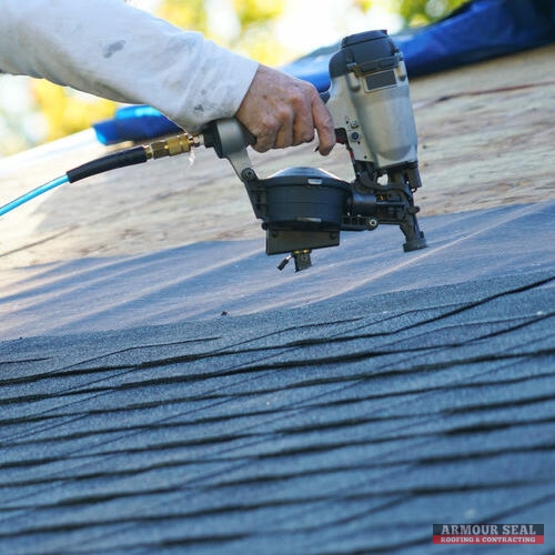 A Roofer Repairs a Roof.