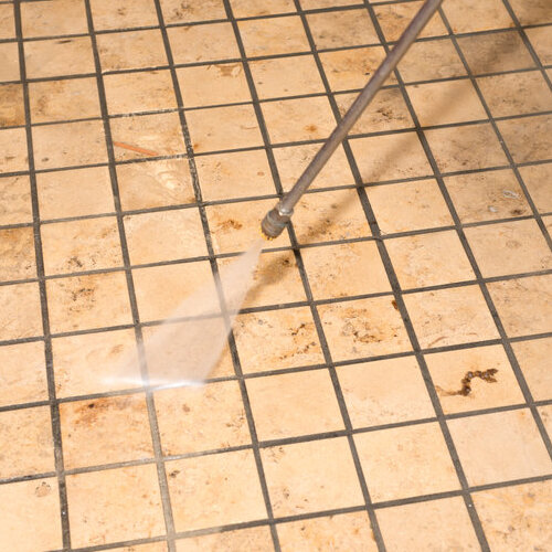 commercial tile floor being pressure washed