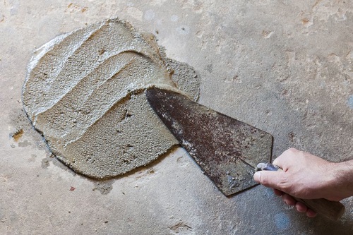 Applying Repairs to a Damaged Section of Concrete